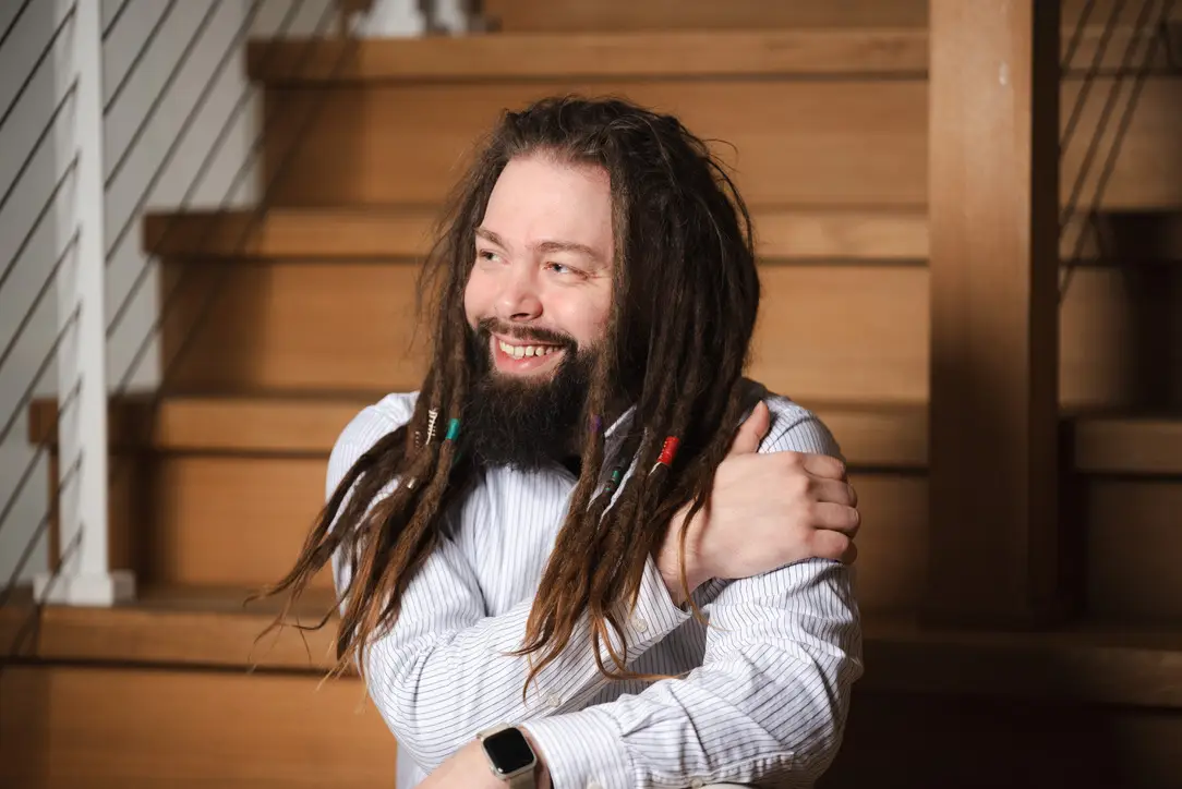 Tommy smiling, looking off-camera